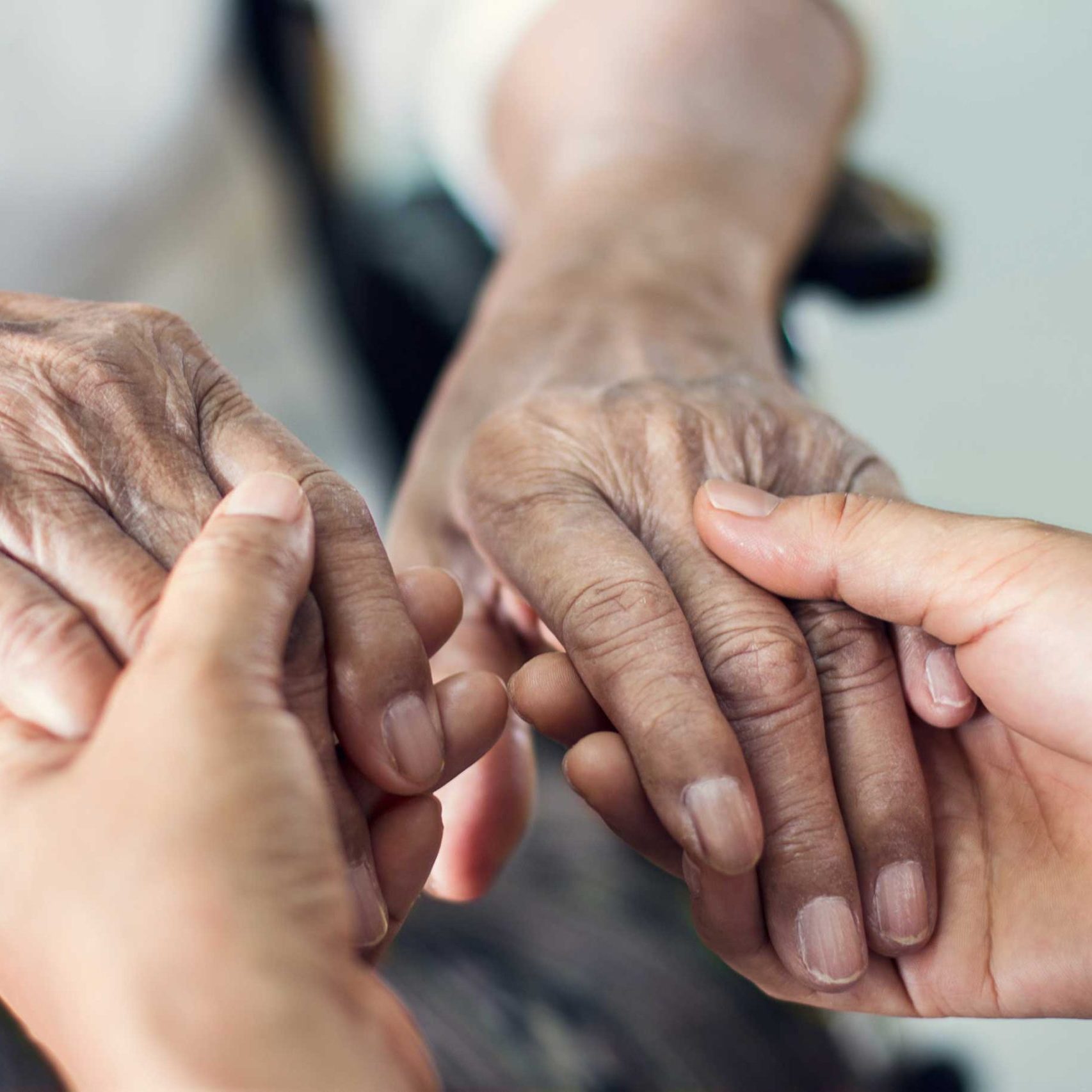 Close up hands of helping hands for elderly home care.