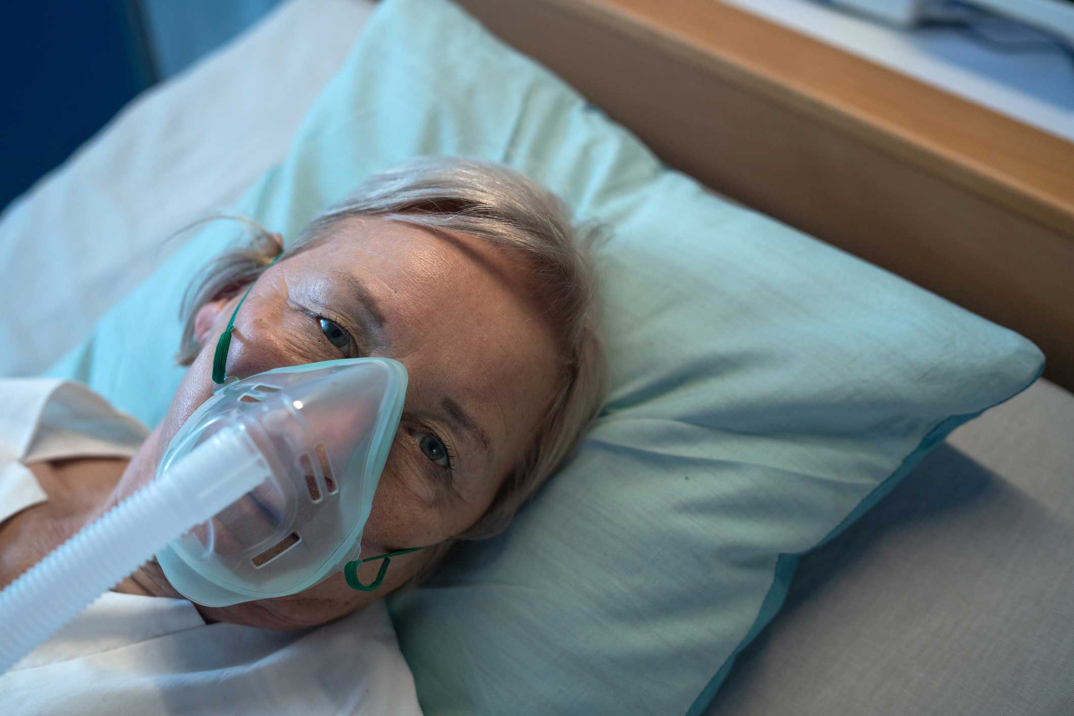 Close-up of covid-19 patient in bed in hospital, coronavirus and ventilation concept